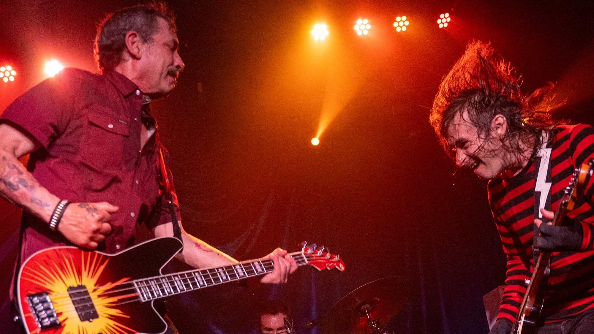 Greg Norton (left) performs live with his Reverend signature bass