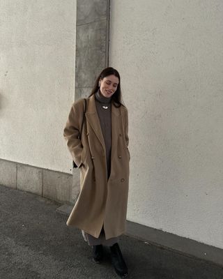 @annabelrosendahl wearing a brown knit dress and long coat