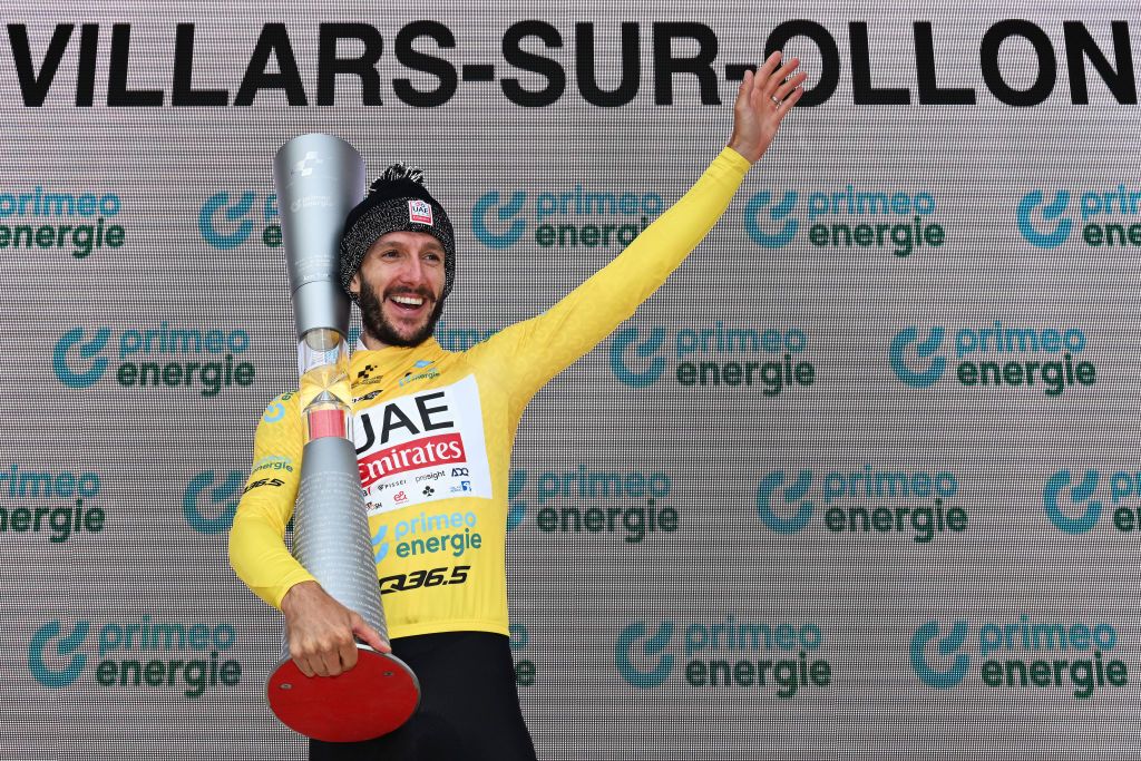 VILLARSSUROLLON SWITZERLAND JUNE 16 Adam Yates of The United Kingdom and UAE Team Emirates celebrates at podium as Yellow leader jersey winner during the 87th Tour de Suisse 2024 Stage 8 a 157km individual time trial stage from Aigle to VillarssurOllon 1249m UCIWT on June 16 2024 in VillarssurOllon Switzerland Photo by Tim de WaeleGetty Images