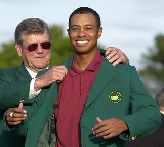 Tiger Woods receives the Green Jacket from Augusta National's chairman in 2002