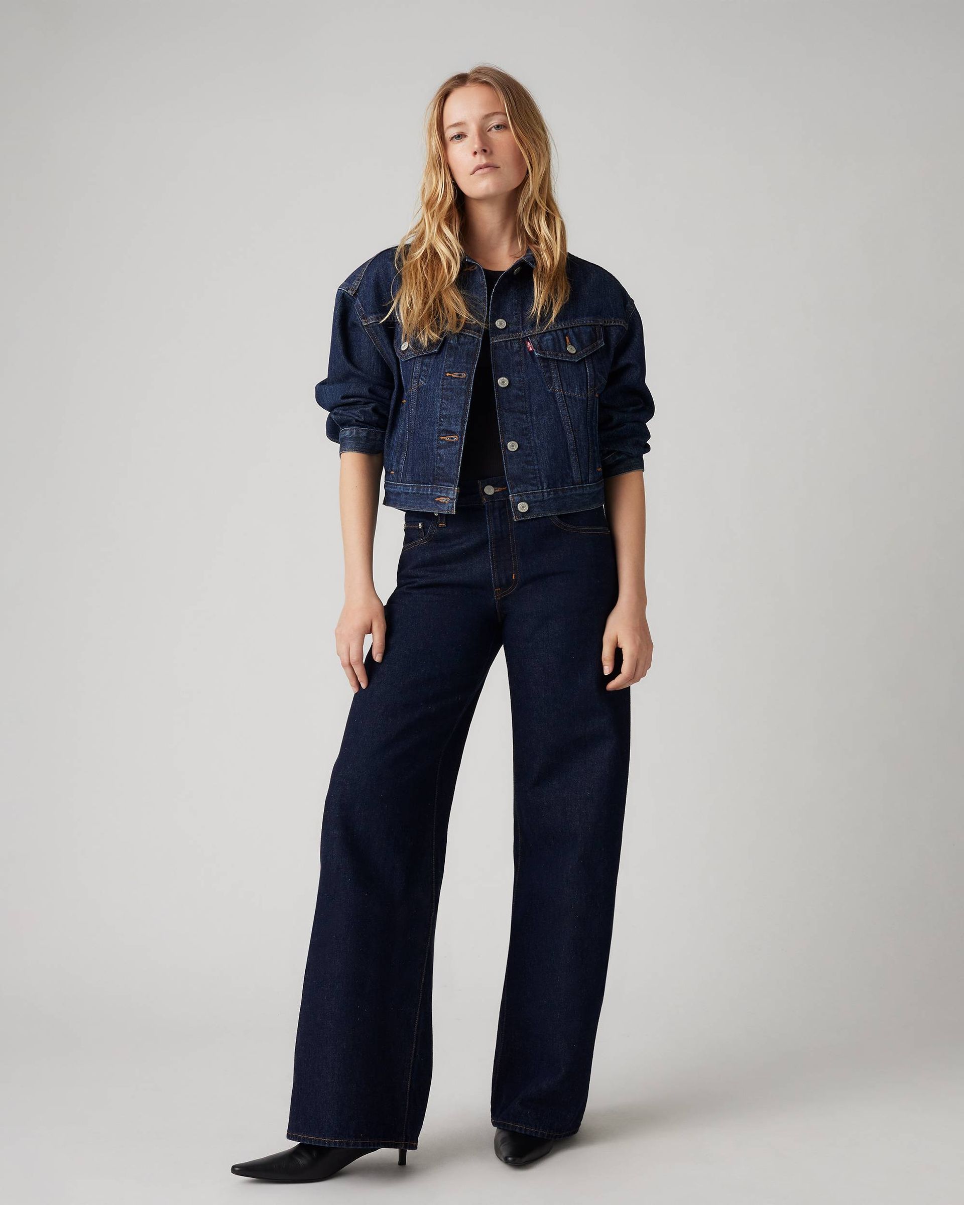 A model wears Levis XL straight jeans and a denim jacket