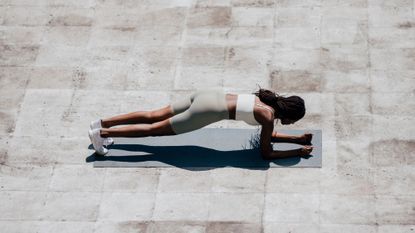 28 day wall Pilates challenge: A woman doing a plank