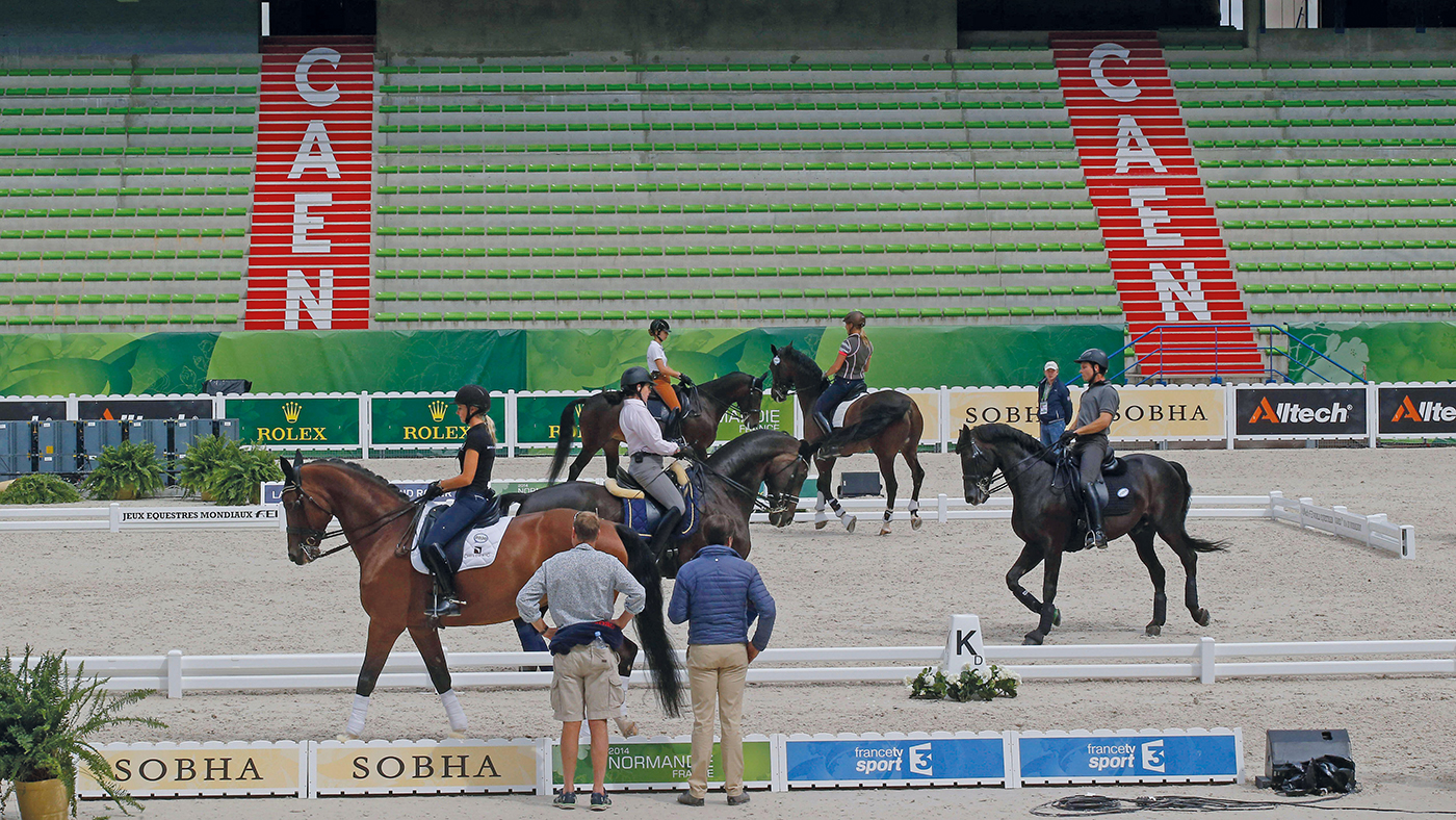Stewards watching the dressage warm-up at the 2014 World Equestrian Games in Normandy.