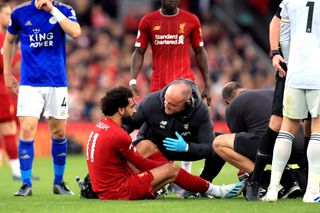 Liverpool’s Mohamed Salah receives treatment after a tackle from Hamza Choudhury