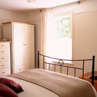 bedroom with bed and white wardrobe
