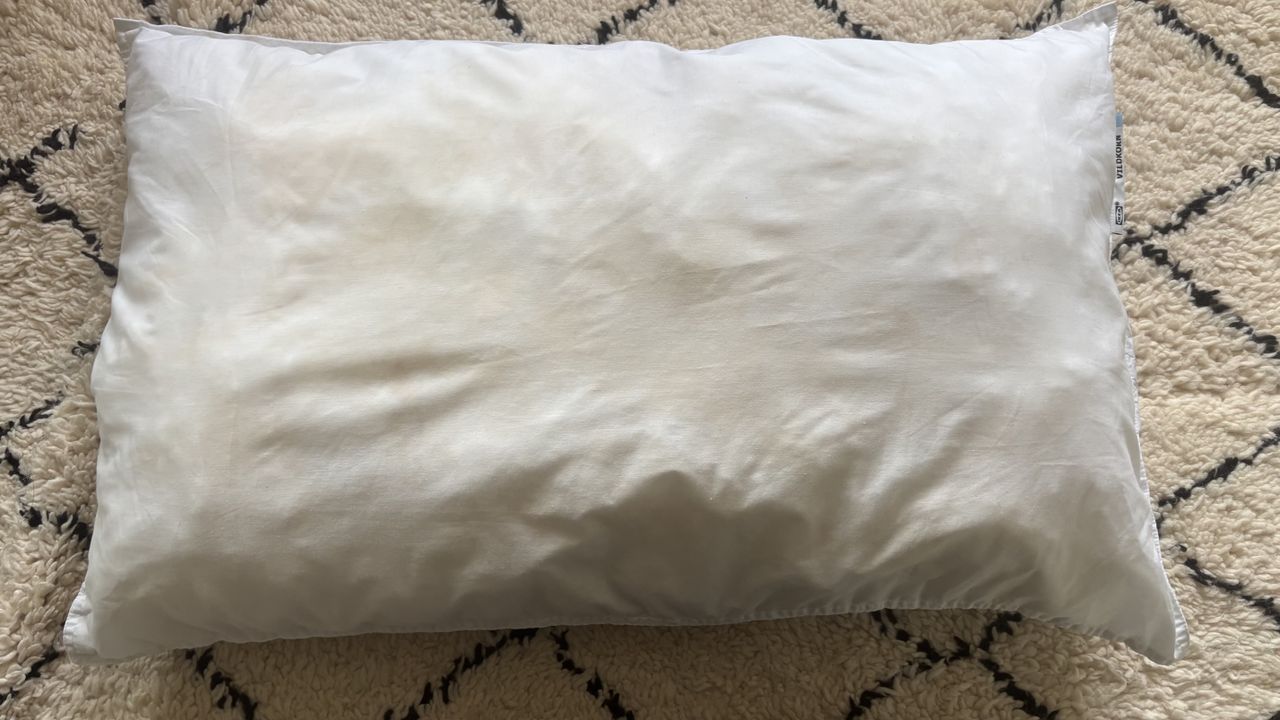 Pillow after being washed with detergent and soda crystals in washing machine.