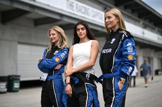 Women wearing IndyCar jumpsuits at the Indy 500.