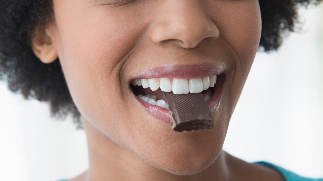 Woman eating milk chocolate