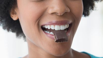 Woman eating milk chocolate