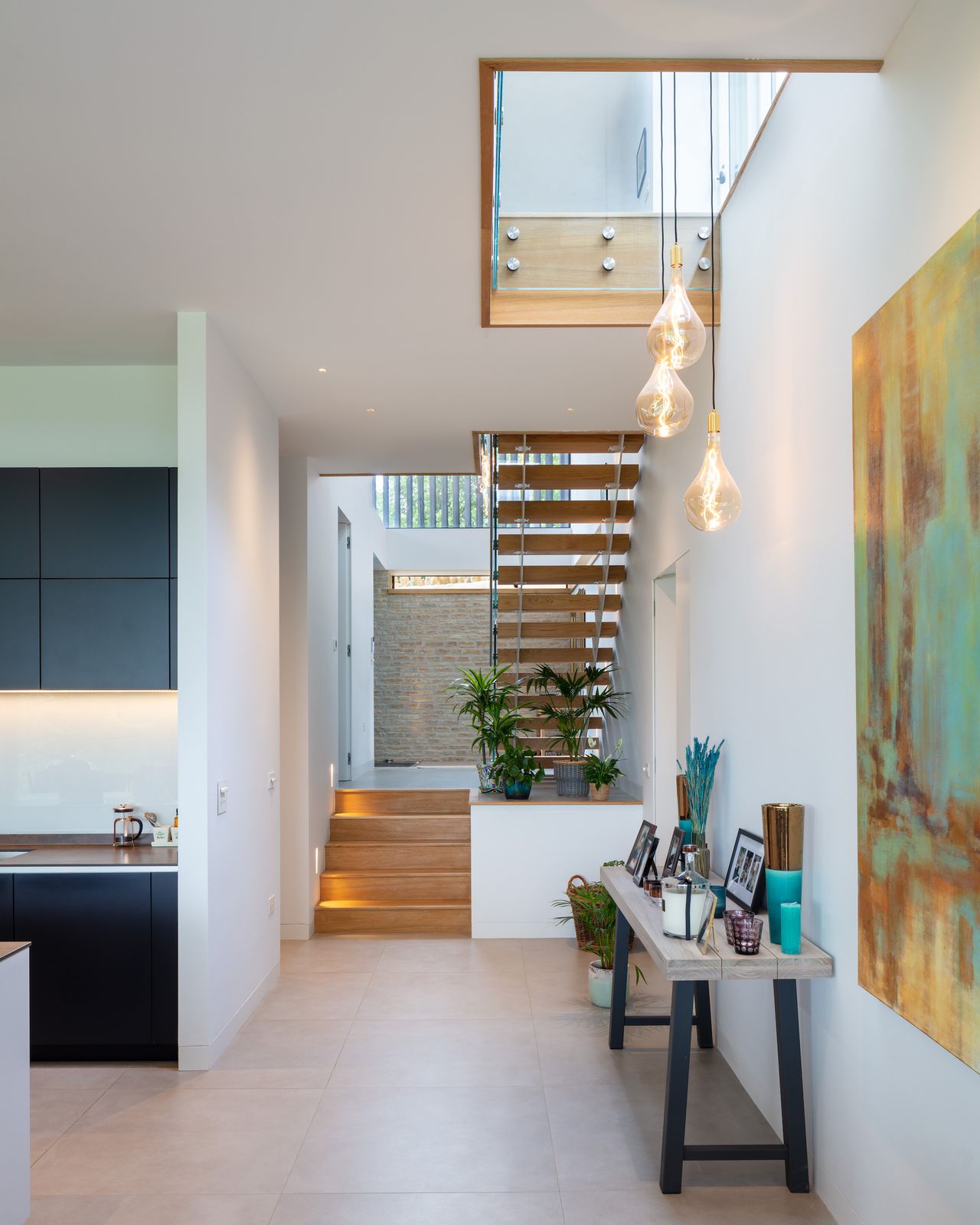 front entrance and hallway with wood and glass staircase