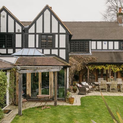 exterior of house with garden and chairs