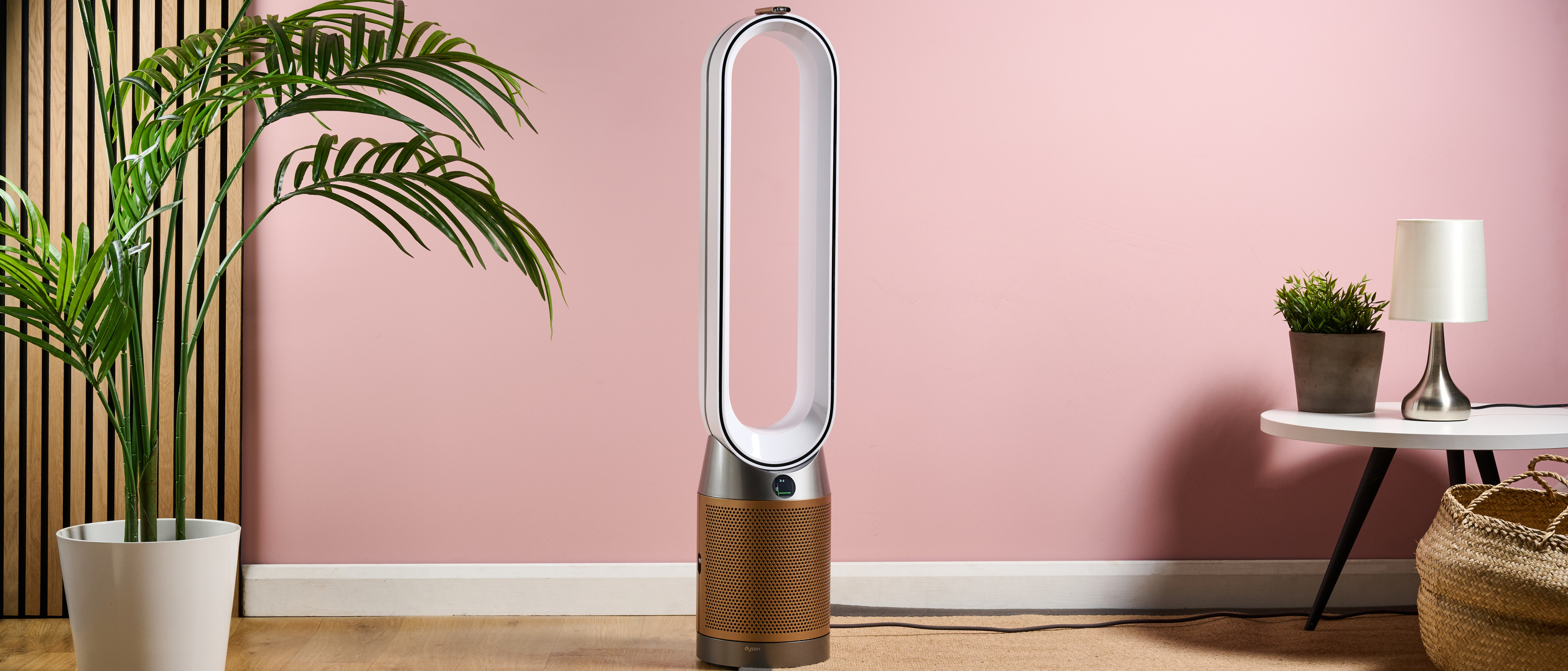 The Dyson Purifier Cool Formaldehyde TP09 sits in the center of a pink living room.