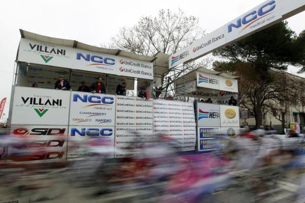 The peloton flash past the start/finish area
