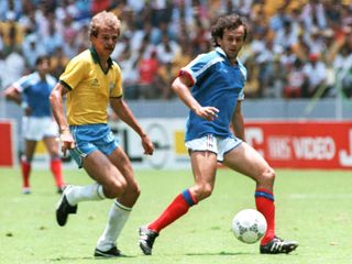 Brazil's Alemao and France's Michel Platini in action at the 1986 World Cup.