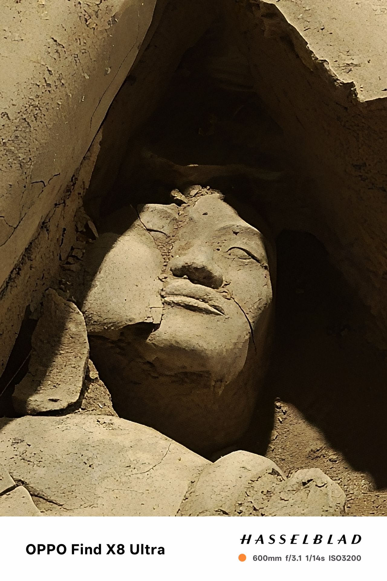 Close up of a statues face on the ground