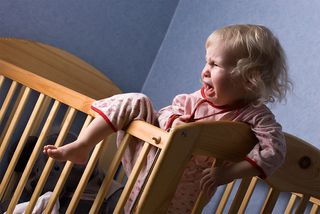 toddler in crib having a temper tantrum