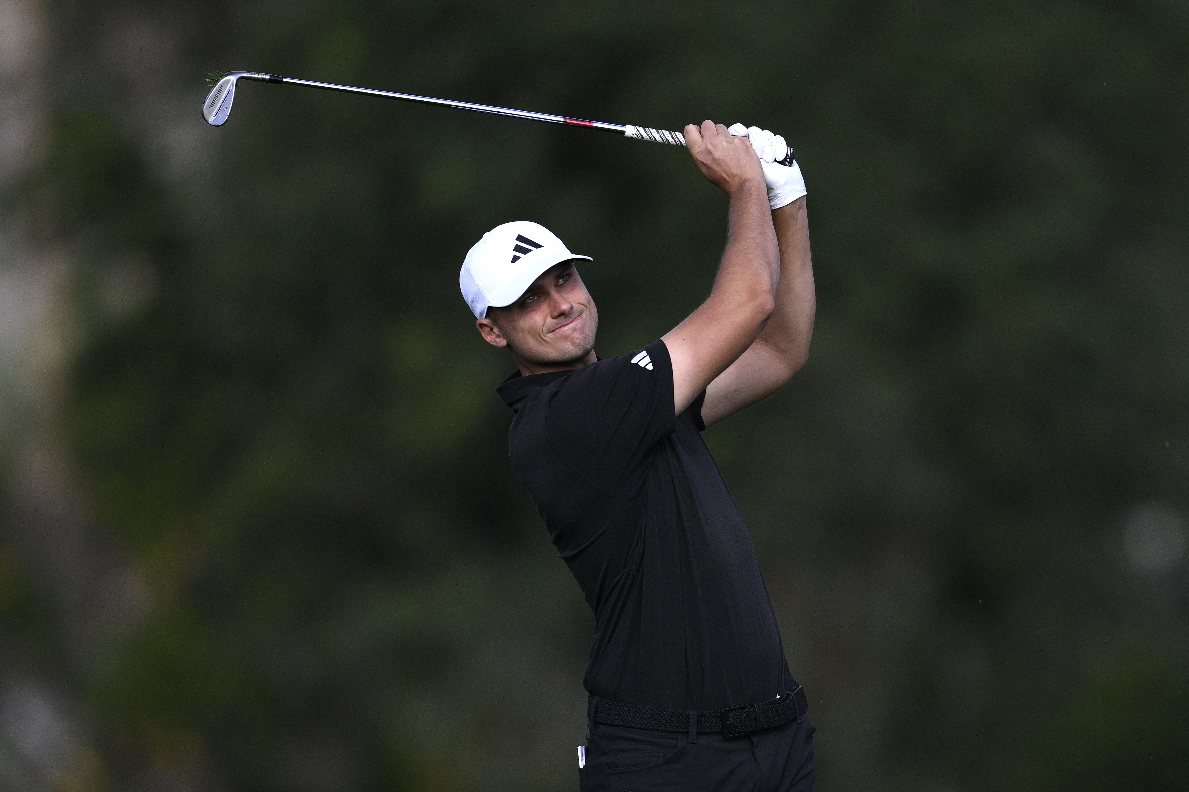 Ludvig Aberg hits a wedge shot into the green