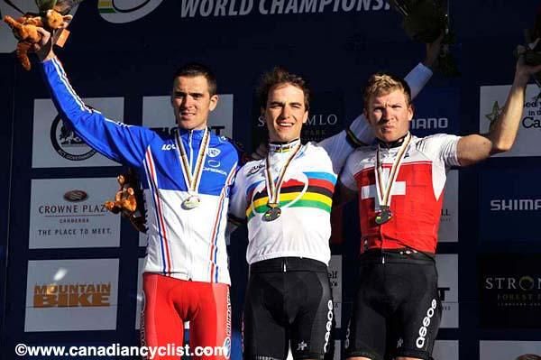 Nino Schurter (Switzerland) on top after the cross country World Championship. Julien Absalon (France) and Florian Vogel (Switzerland), l &amp; r.