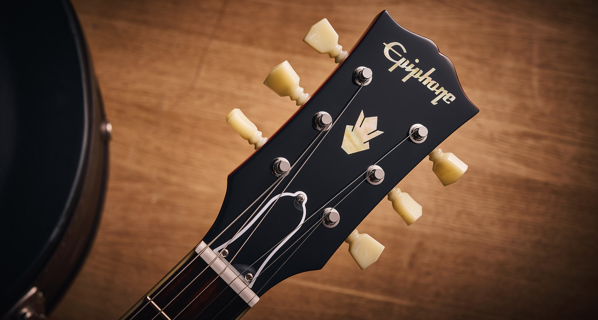 Epiphone Inspired By Gibson Custom 1962 ES-335 Reissue: the handsome semi-hollow electric is finished in Sixties Cherry and is photographed against various backgrounds.