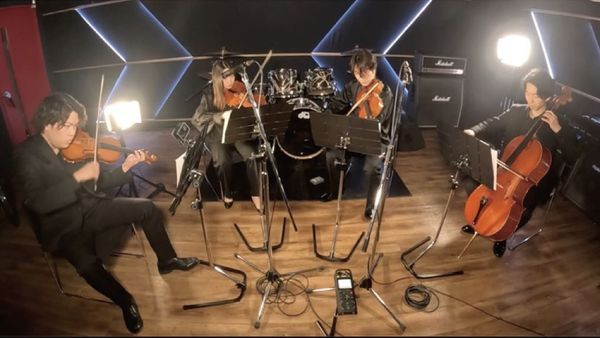 String quartet playing music in a studio,