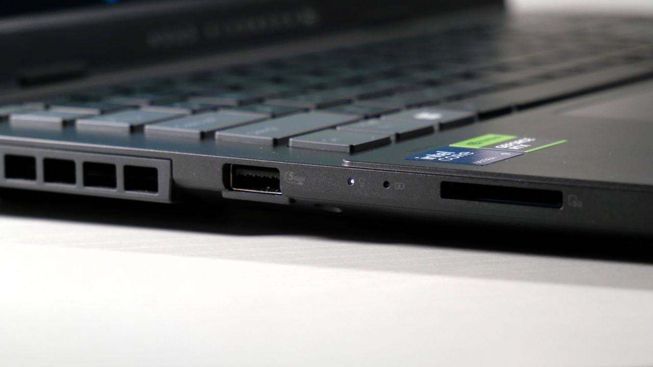 Asus Vivobook Pro 15 (N6506, 2025) on a white table, highlighting the ports on the left, including a USB Type-A port and an SD card slot.