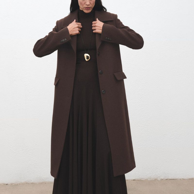 Wool coat with fur collar on model 