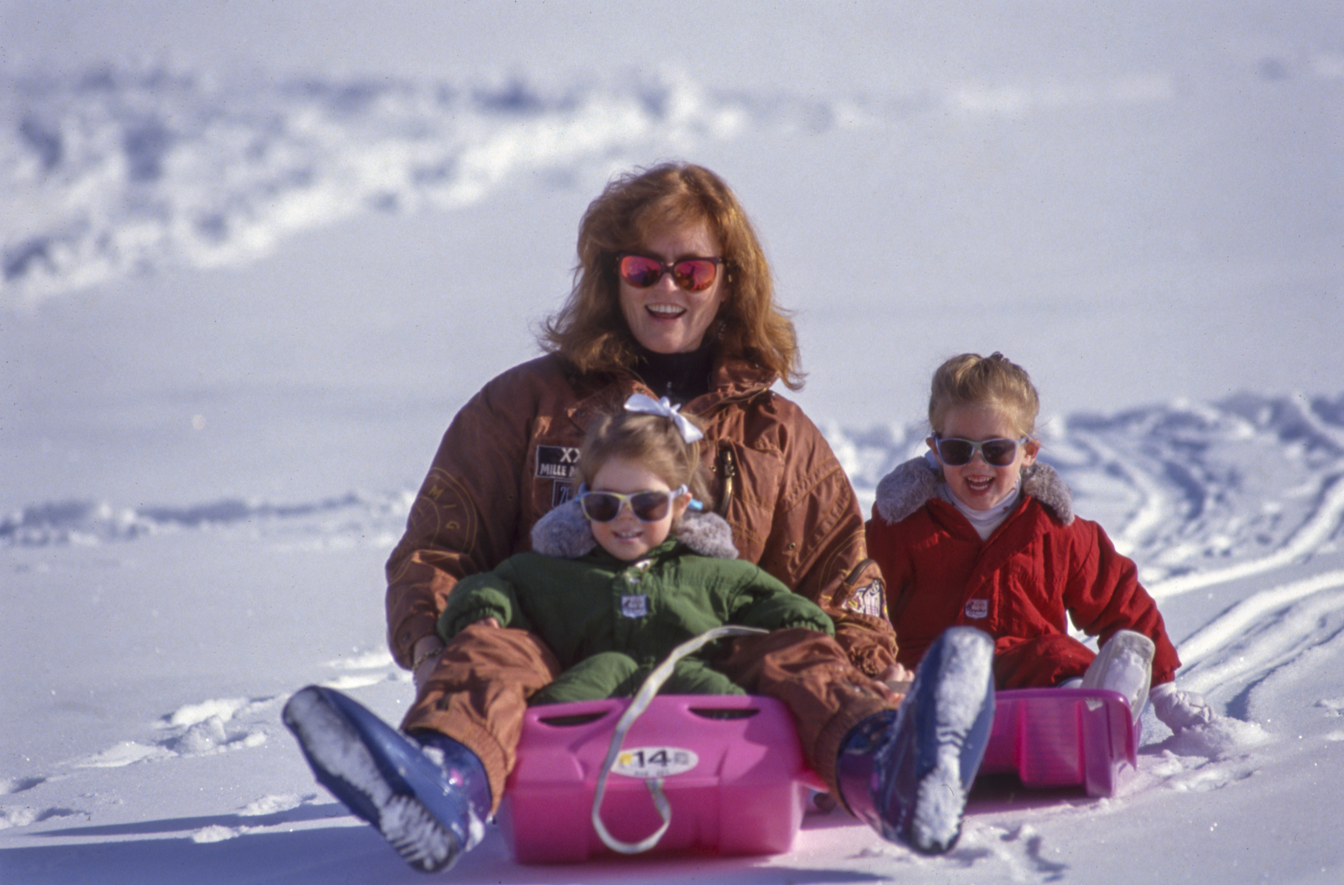 Sarah Ferguson sledding with Princess Beatrice and Princess Eugenie in 1993