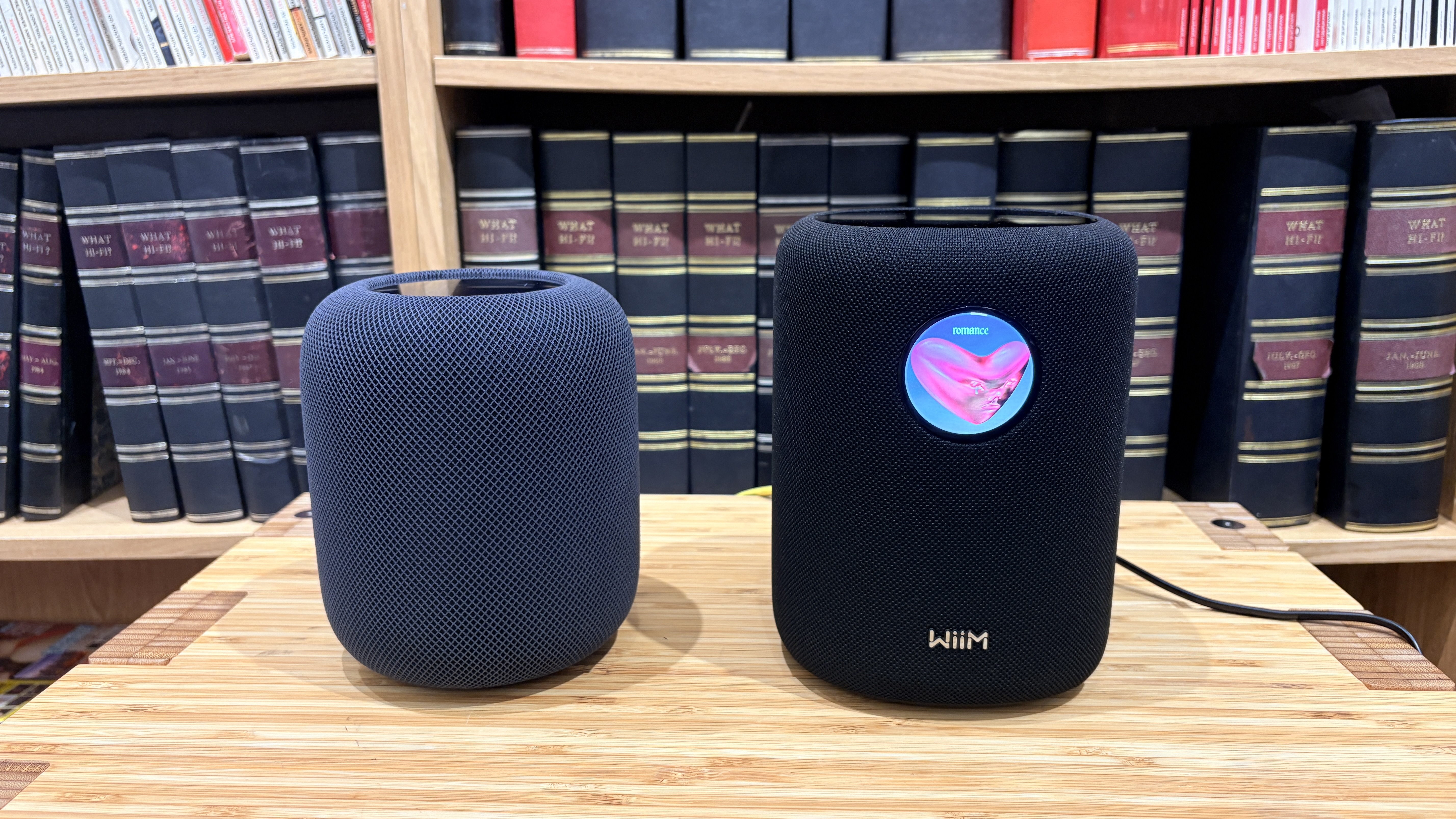 Apple HomePod 2 and WiiM Sound speakers on wooden surface
