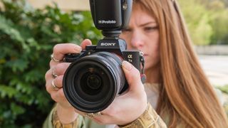 Sony A7 III camera being used by a person looking at the screen