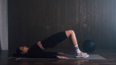 A woman performing glute bridges