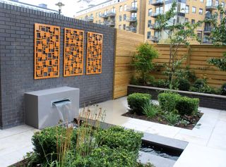 Modern garden with laser cut panels on a garden wall