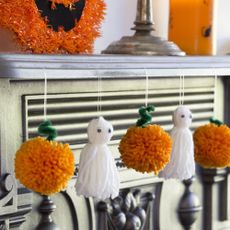 halloween decor with white dolls and marigold flowers