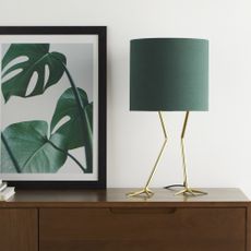 white wall with flamingo lamp and gold legs