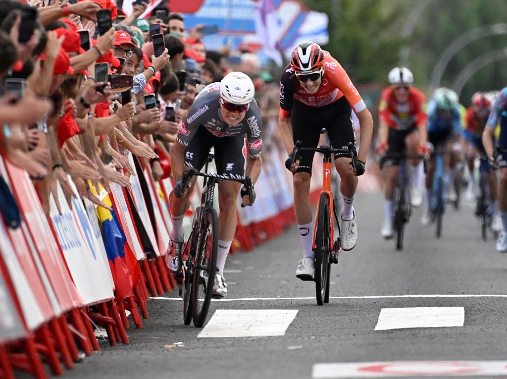 Team Alpecin's Belgian rider Jasper Philipsen (L) competes before crossing first the finish line of the 19th stage of the Vuelta a Espana, a 159 km race between Rueda and Guijuelo, in Medina del Campo on September 12, 2025. (Photo by Miguel RIOPA / AFP)