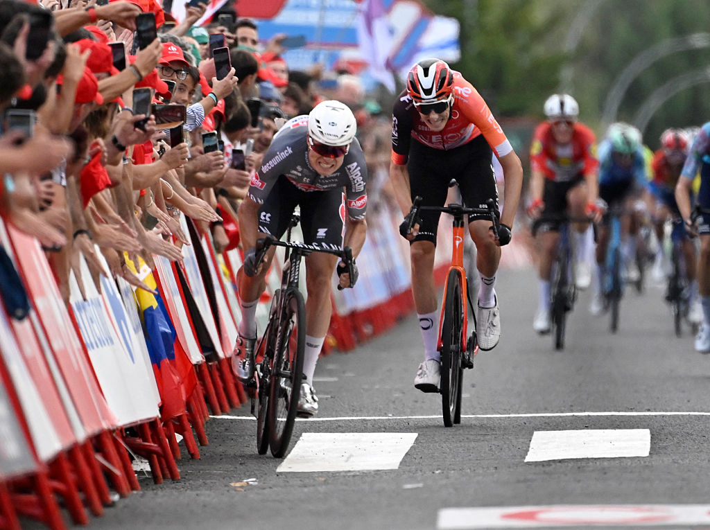 Team Alpecin's Belgian rider Jasper Philipsen (L) competes before crossing first the finish line of the 19th stage of the Vuelta a Espana, a 159 km race between Rueda and Guijuelo, in Medina del Campo on September 12, 2025. (Photo by Miguel RIOPA / AFP)