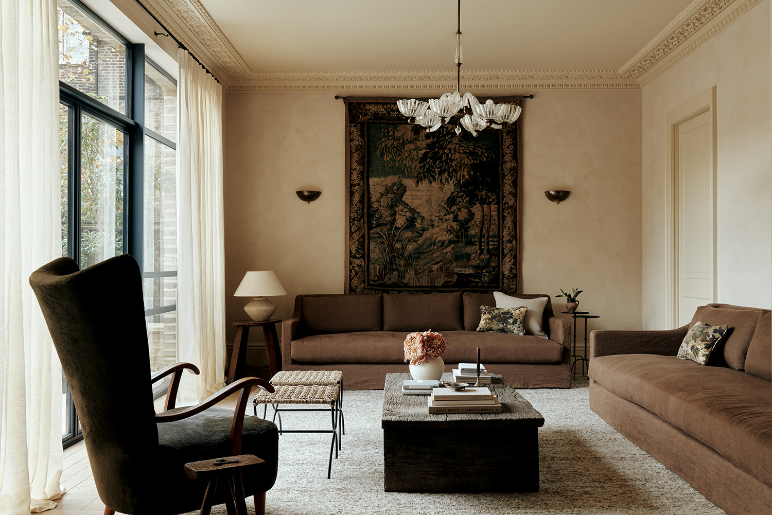 living room with neutral walls and brown sofas