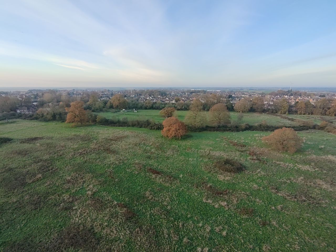 Photo of a meadow and town taken with the HoverAir X1 PRO drone