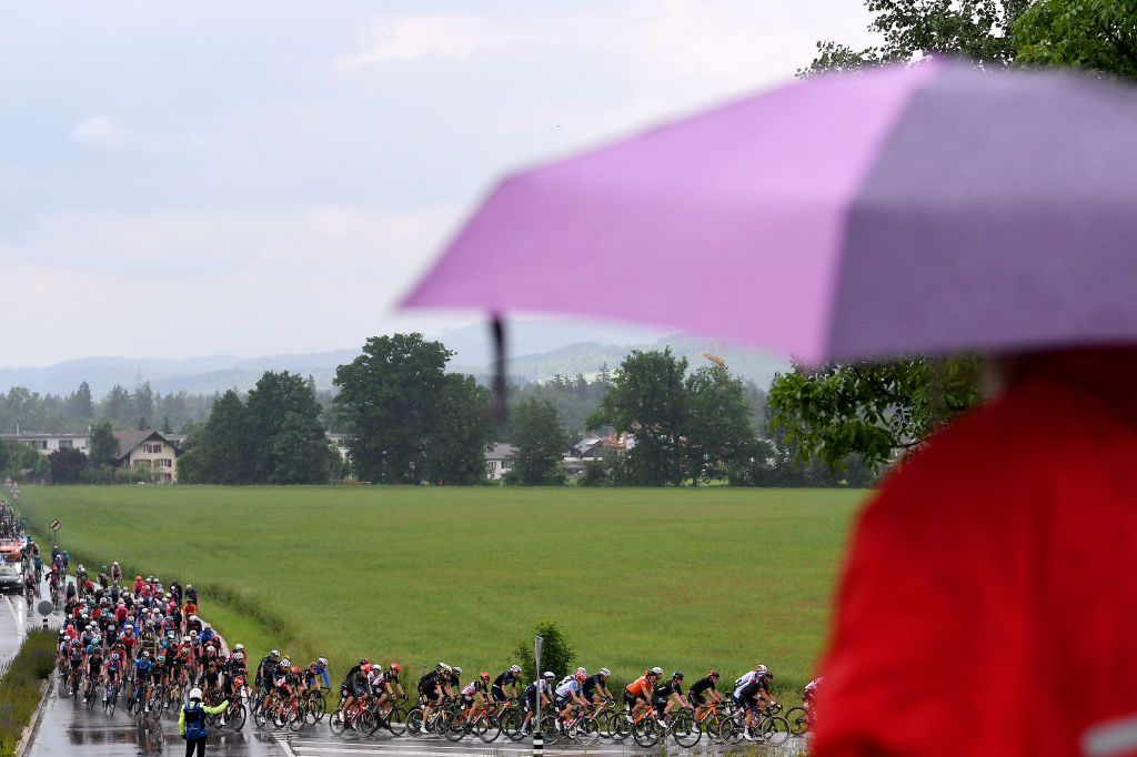 GSTAAD SWITZERLAND JUNE 09 The Peloton during the 84th Tour de Suisse 2021 Stage 4 a 171km stage from St Urbanto Gstaad 1004m Rain Fans Public UCIworldtour tds tourdesuisse on June 09 2021 in Gstaad Switzerland Photo by Tim de WaeleGetty Images