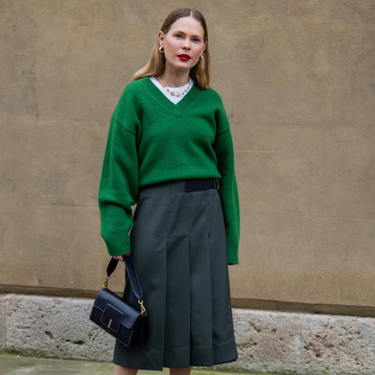 5 ways to wear v-neck jumpers listing - green jumper grey skirt