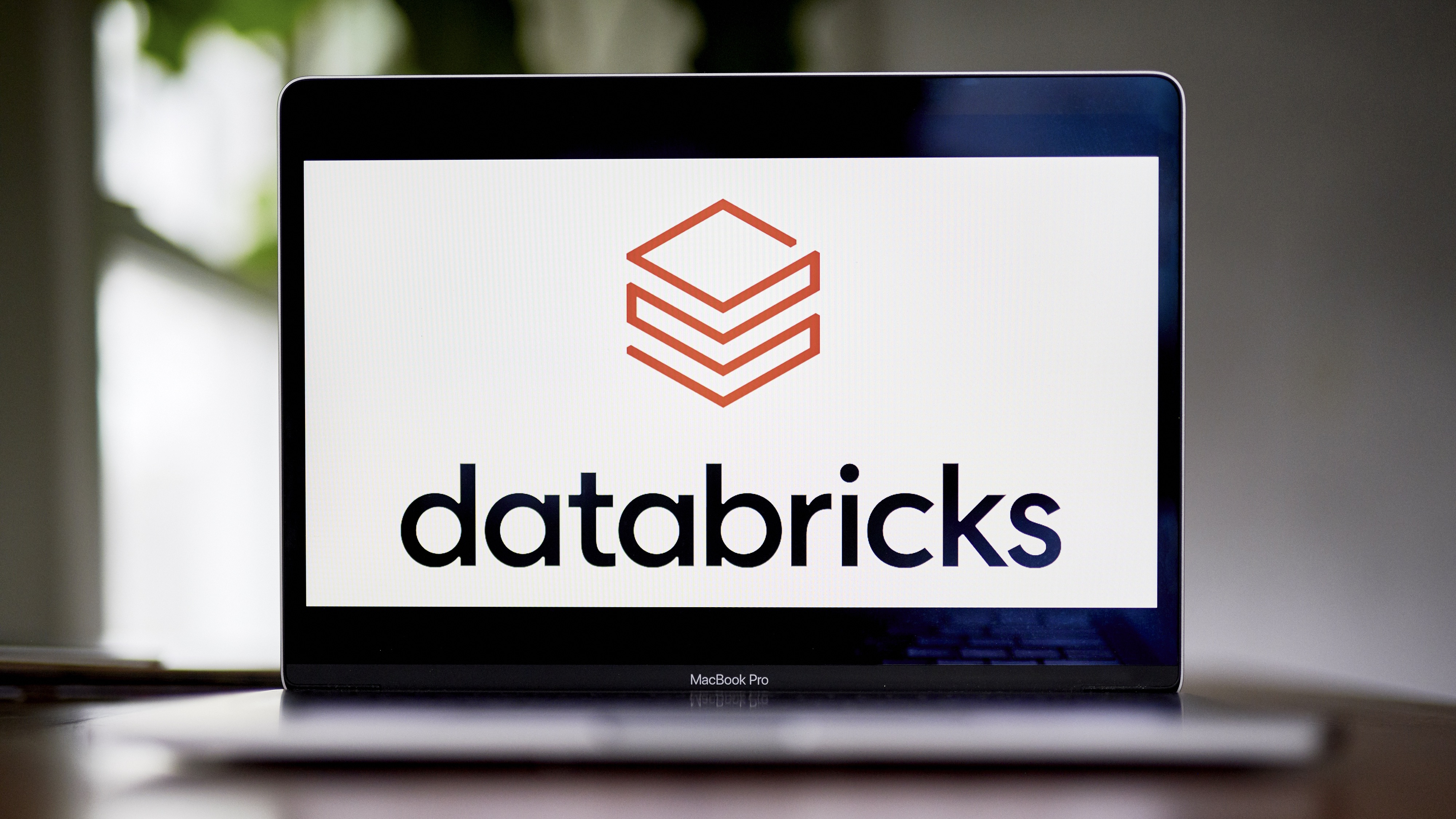The Databricks logo on a Macbook Pro
