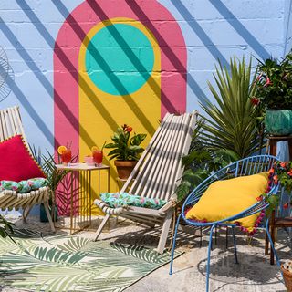 coloured garden wall mural with garden chairs