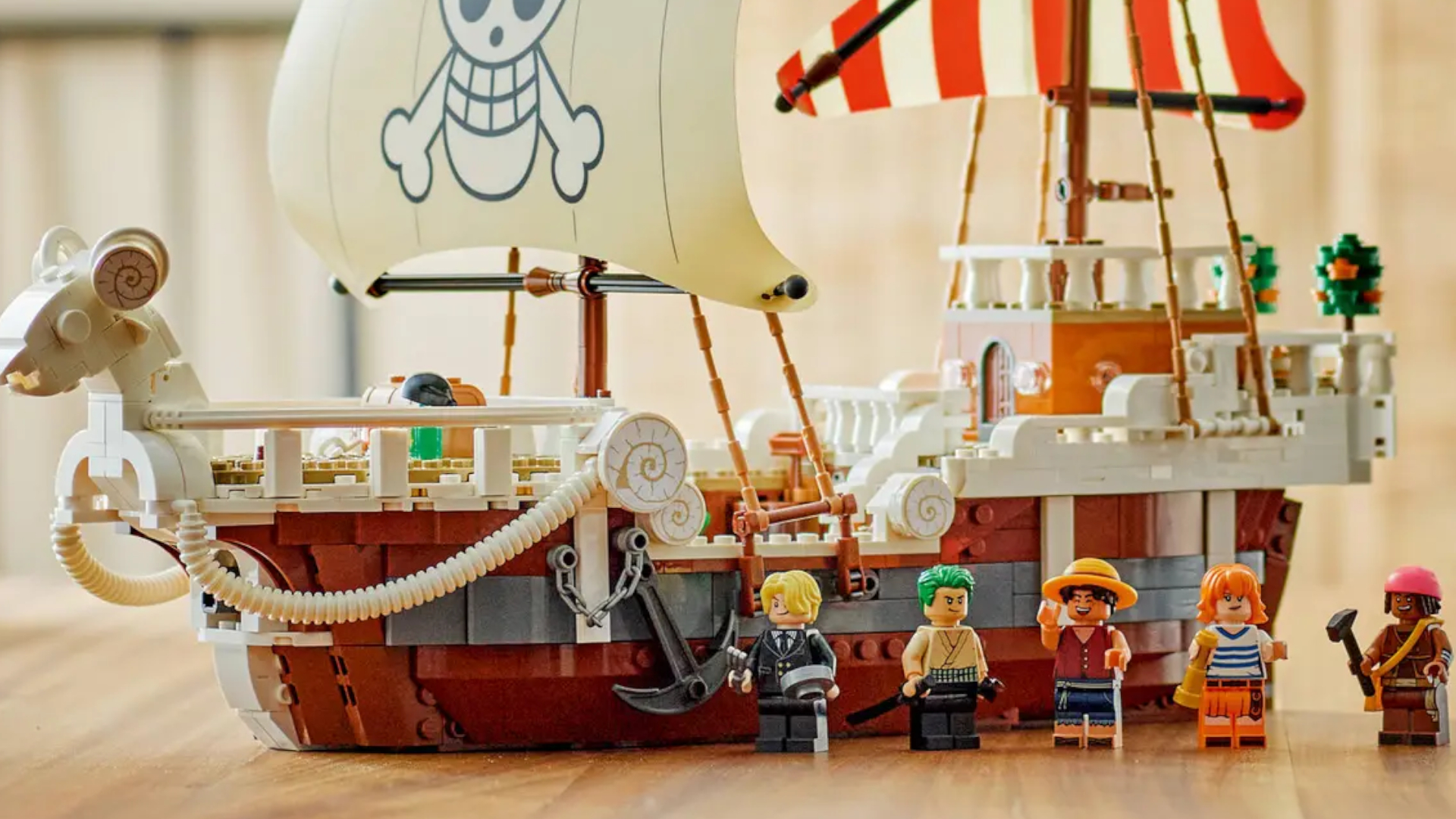 Lego The Going Merry Pirate Ship set and minifigures laid out on a wooden table