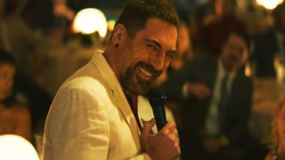 Javier Bardem's Max smiling as he holds a microphone in Apple TV's Cape Fear TV show