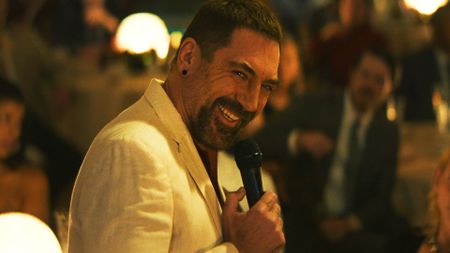 Javier Bardem's Max smiling as he holds a microphone in Apple TV's Cape Fear TV show