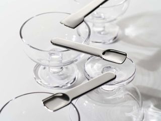 steel spoons on top of glasses