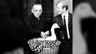 black and white photograph of Per Enflo holding a basket with a goose inside.