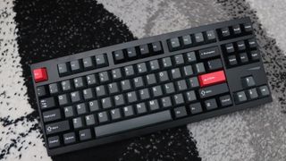 Lemokey L4 gaming keyboard on a carpet with lighting enabled.