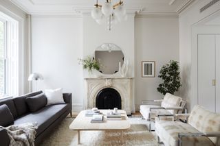 a stylish neutral living room with a marble fireplace