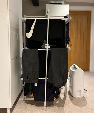 airer with clothes and dehumidifier stood to one side