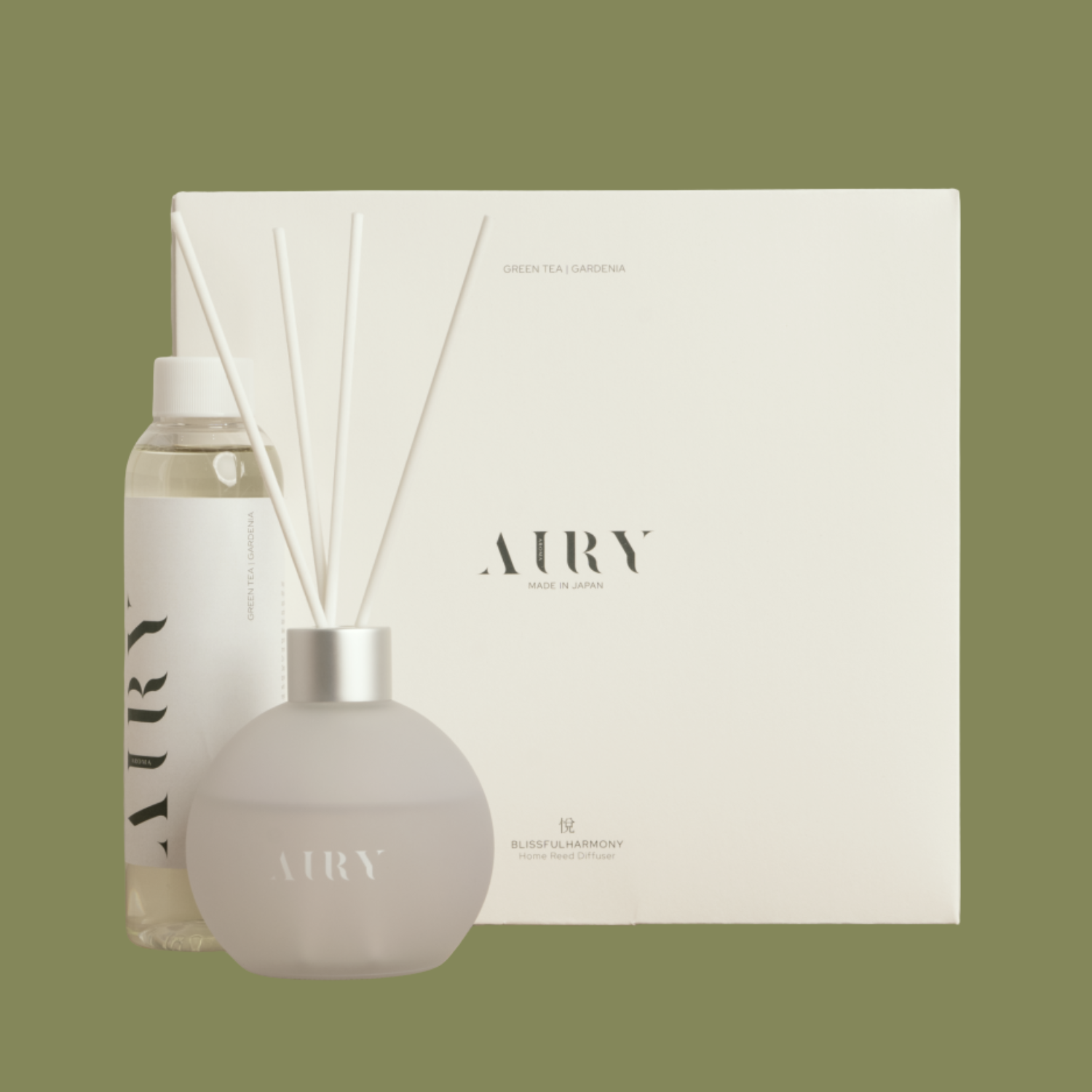 A frosted glass reed diffuser beside a refill bottle and a box